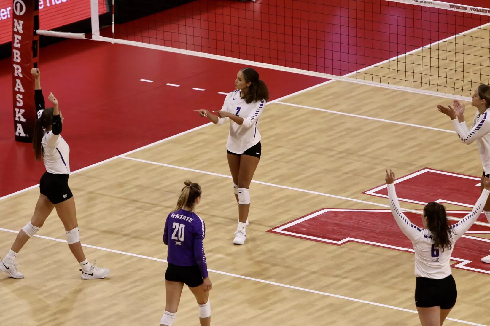 K-State celebrates a point against Colgate at the Husker Invitational on Friday.