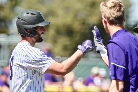 TK McWhertor high-fives a teammate vs. Baylor at Tointon Family Stadium on April 28, 2018.