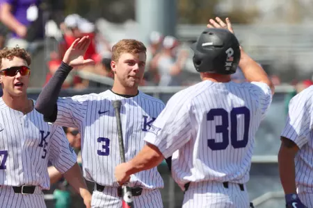 Drew Mount (#30) and Cam Thompson (#3) high five after Mount scores vs. Baylor at Tointon Family Stadium on April 28, 2018.