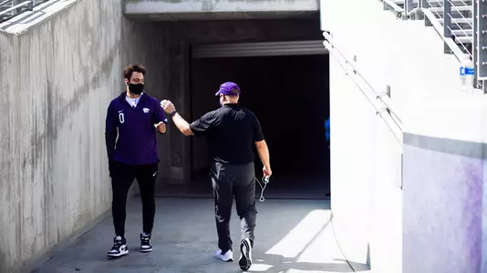 Briley Moore dabs up Chris Klieman before K-State faces TCU