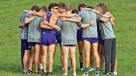 K-State runners huddle up before a meet in Lawrence
