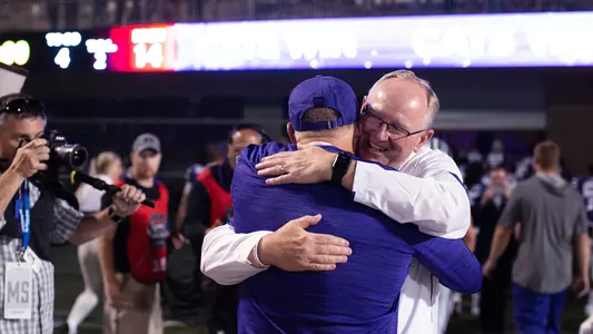 Gene Taylor congratulates Chris Klieman after a K-State win