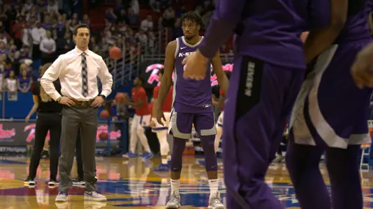 Mason Schoen watches warmups before K-State takes on Kansas