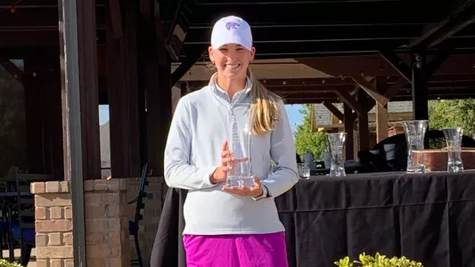 Reid Isaac Holding the Schooner Fall Classic Trophy