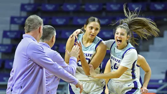 K-State’s Ayoka Lee, Rebekah Dallinger, and the Wildcats celebrate after the game against Baylor at Bramlage Coliseum in Manhattan, Kansas on January 2, 2022.