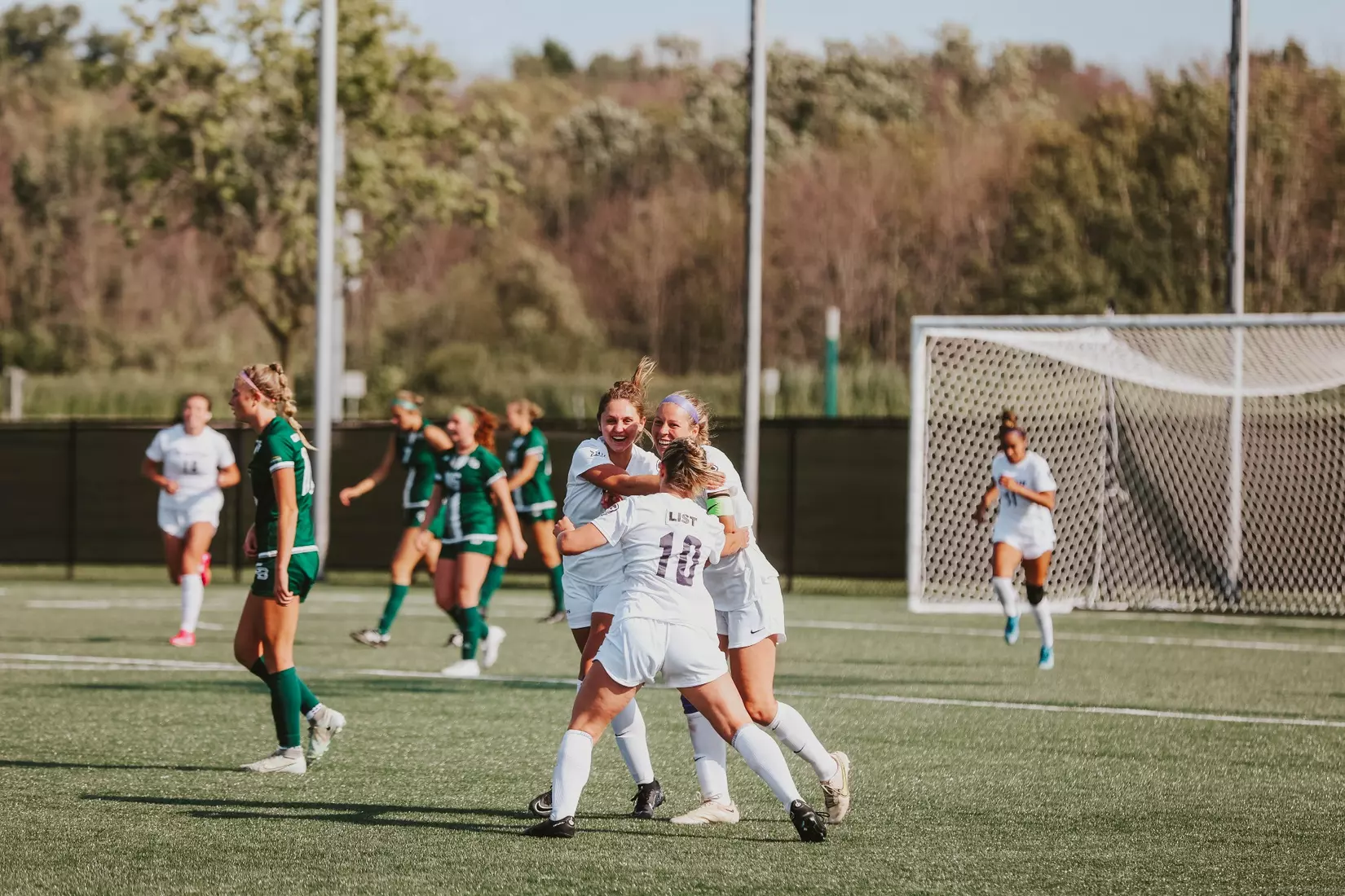 K-State's Aliyah El-Naggar celebrates with Andra Mohler and Porter List (10).