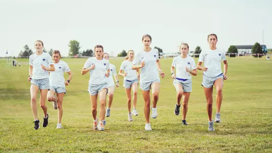 Women's cross country team warming up at 2022 Bob Timmons Classic