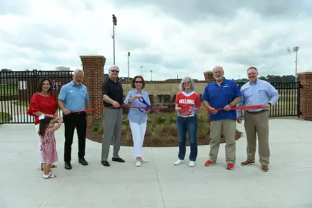 Ribbon cutting for the Jim Mize Track and Field Complex entrance and fence