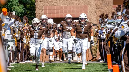 FB Team Running Out Cornell
