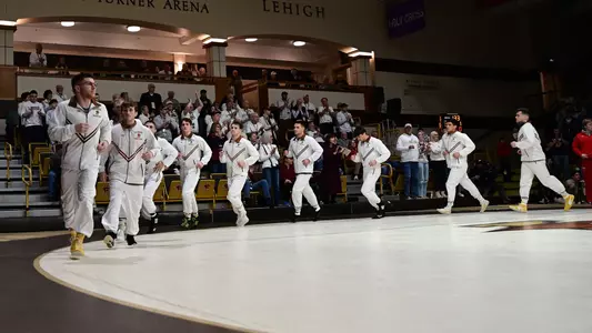Team running around mat Cornell