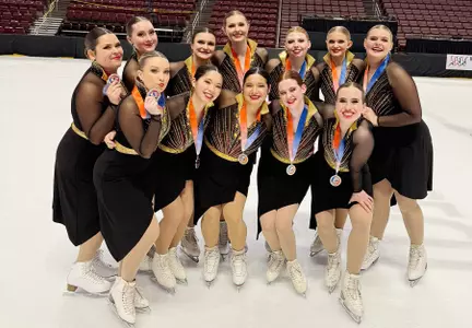 Synchronized skating team portrait with medals