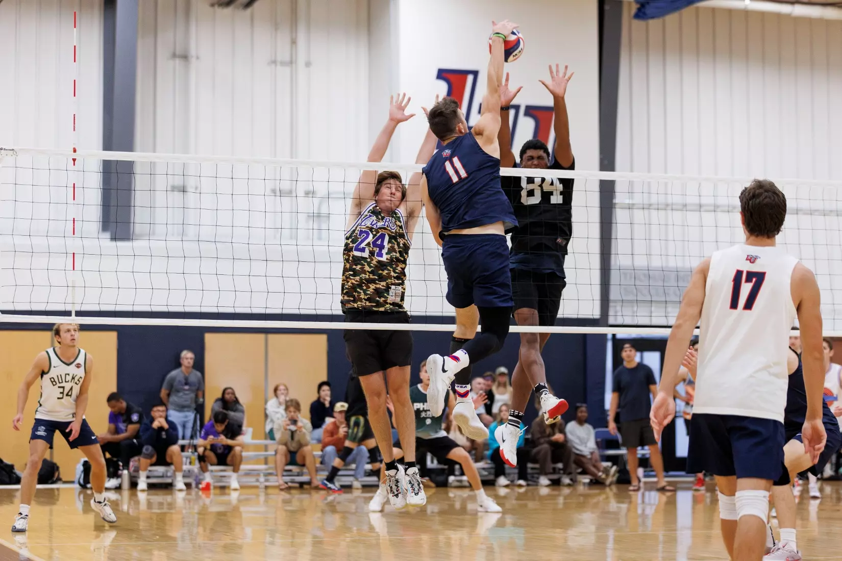 The Liberty Men’s Indoor Volleyball team faces an LU Alumni team at the Preseason ECVF Tournament in the Lahaye Multipurpose Center on October 18th, 2025. (Photo by Grace Greer)