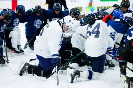 Boys hockey camp prayer huddle