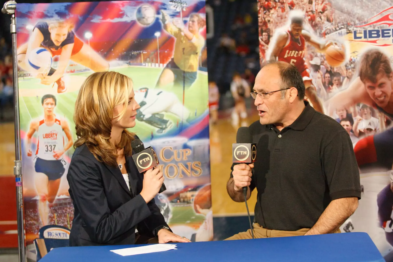 Samantha Steele interviews Liberty Wrestling coach Jesse Castro during the Men's basketball game against Presbyterian on February 9, 2009. (Photo by Les Schofer)