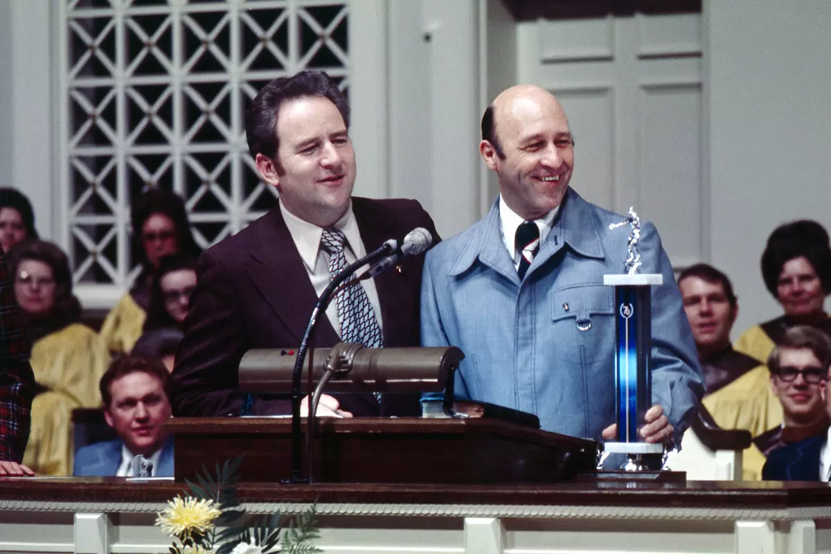 Coach Bonheim presenting a wrestling trophy to Jerry Falwell Sr. in May, 1977. (Photo by Les Schofer)