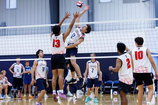 Andrew Williams spikes in home volleyball tournament