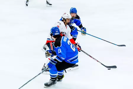 ROman Lamoureux skates between MTSU players