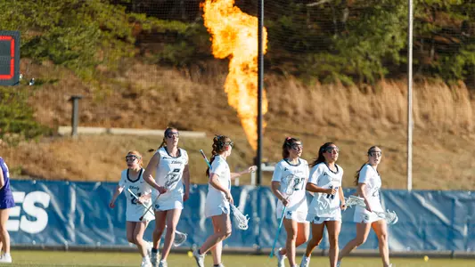 Team walks in front of flames