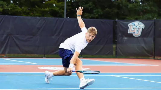 Stinchcomb reaches for a volley