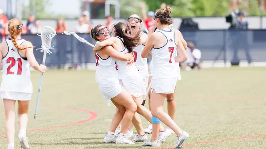 Women's Lacrosse team celebrates following a goal