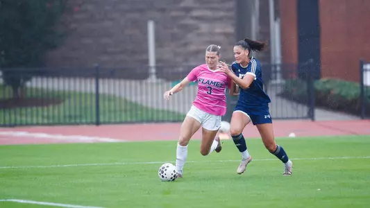 Women's Soccer Holds off a defender in a game against FIU