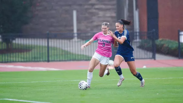 Women's Soccer Holds off a defender in a game against FIU