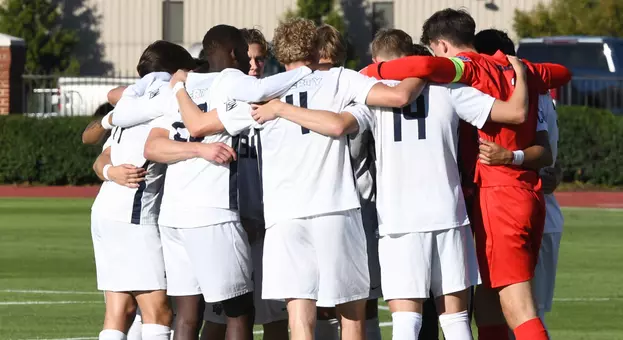 Men's Soccer - Liberty on field in huddle before start of game