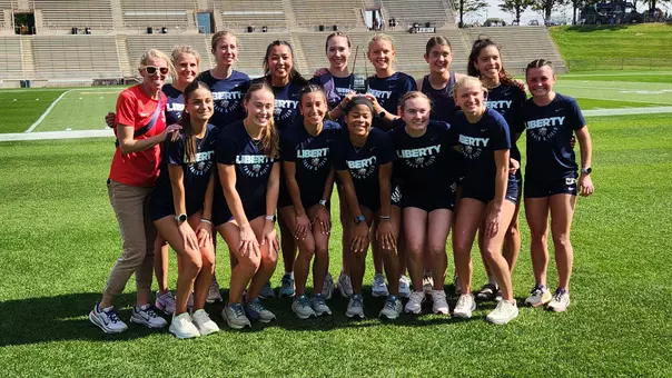 The Liberty women's cross country team celebrates the women's 6K gold race team title at the Paul Short Run, Oct. 2, 2026 in Bethlehem, Pa.