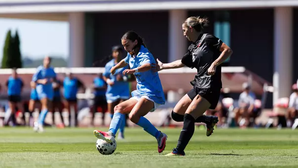 Women's Soccer Audrey Heustis dribbles the ball in a game at Osborne Stadium