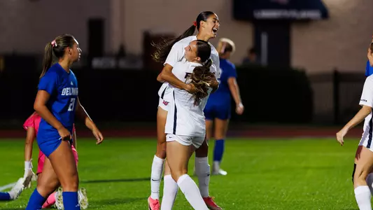 Women's Soccer Margaret Garner celebrates a goal with Halle Engle in a game at Osborne Stadium