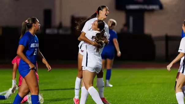 Women's Soccer Margaret Garner celebrates a goal with Halle Engle in a game at Osborne Stadium
