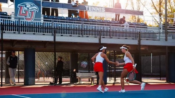 Women's Tennis Milana Tsulygina and Candy Wai following a point at the Liberty Tennis Complex