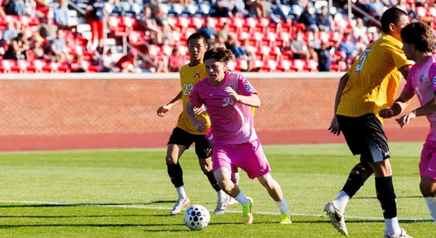 Men's Soccer - Ronnie Gorman Moves Past a VMI Defender
