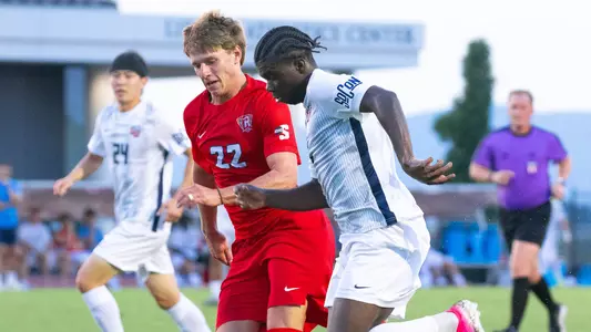 Men's Soccer - Samson Kpardeh dribbles past a defender