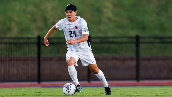 Men's Soccer - Kyohei Eguchi dribbles ball up the field