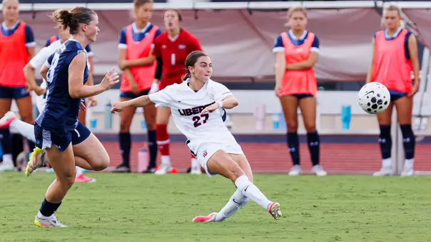 Women's Soccer Audrey Heustis Passes for an assist in a game against Old Dominion