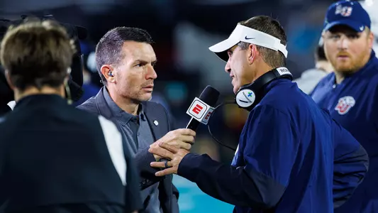 Head Coach Jamey Chadwell speaks with ESPN sideline reporter - Liberty University’s Football team takes on the Coastal Carolina Chanticleers at Brooks Stadium on September 24, 2026. (Photo by Grace Greer)