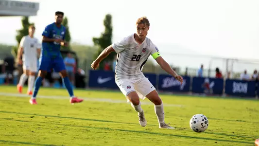 Men's Soccer - Defender Roope Salo Looks to Clear Ball