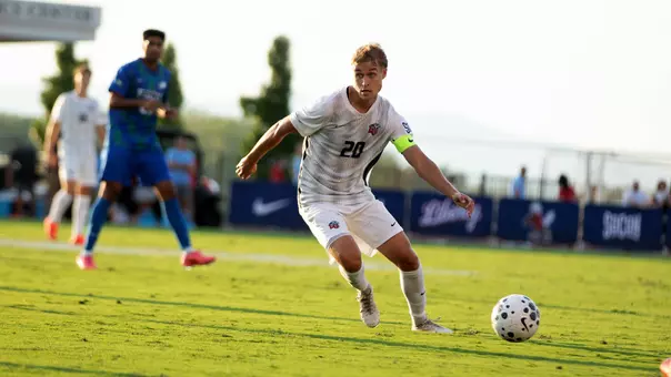 Men's Soccer - Defender Roope Salo Looks to Clear Ball