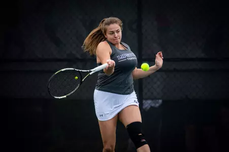 Kate Popova hitting tennis ball