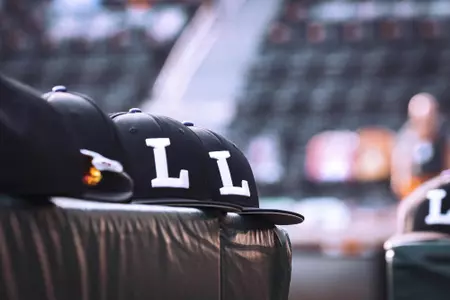 Baseball Hats on Dugout rail