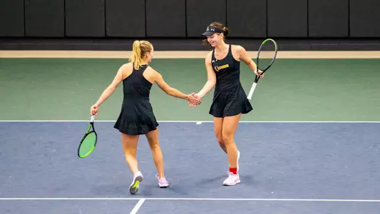 Perri Howard and Liza Diachenko high-fiving after a point