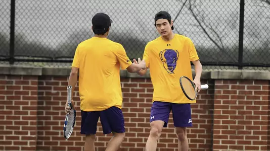Henrique Ushizima and Vikash Singh High-Fiving