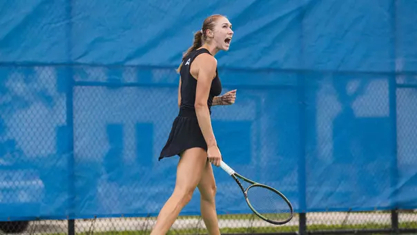 Mariia Dolzhenko with fist clenched after winning a point