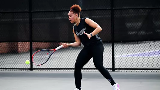 Leena Hamdan hitting a tennis ball with a racquet