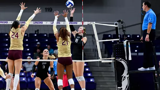 Ella Durham attacking at the net with a volleyball