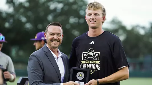 Kaleb Kantola with ASUN Commissioner Jeff Bacon accepting his All-Tournament plaque