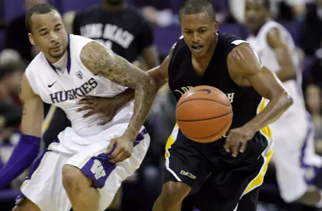 Long Beach State's Greg Plater, right, tries to beat Washington's Venoy Overton to a loose ball in the first half of an NCAA college basketball game Tuesday, Nov. 30, 2010, in Seattle. (AP Photo/Elaine Thompson)