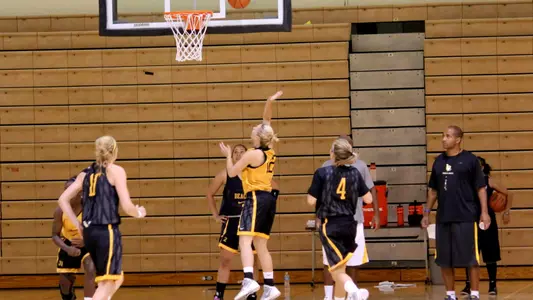 Sigrid Skorpen (12) goes for the layup while Ella Clark (10) and Lauren Spargo (4) look on.