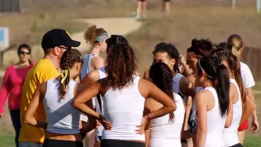 LBSU distance coach Patrick Cunniff talks to the women's team at last Saturday's Bronco Invitational. (Photo by Andy Sythe)